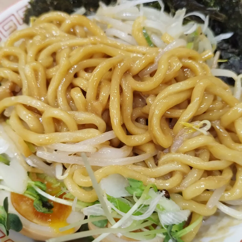 混ぜた後の油そば — タレ・油・麺が一体化した黄金色の輝き